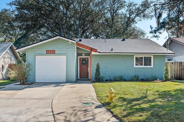 ranch-style house with stucco siding, an attached garage, fence, driveway, and a front lawn