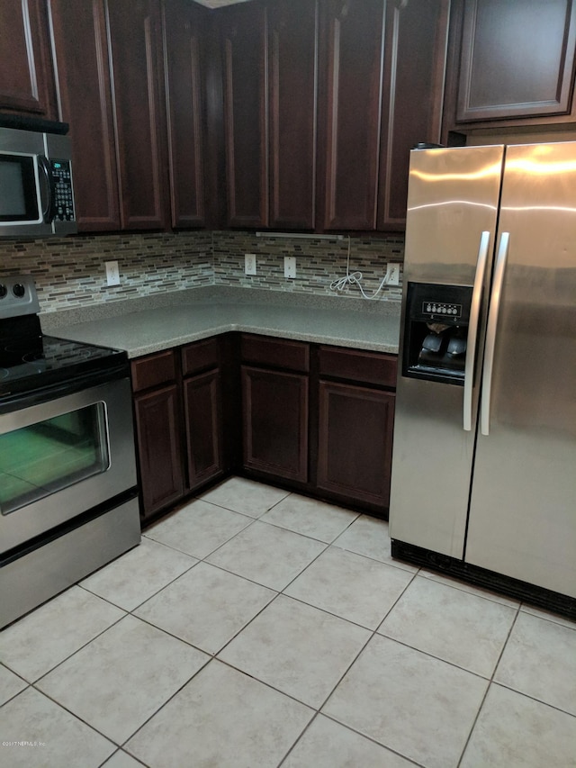 kitchen featuring backsplash, stainless steel appliances, and light countertops