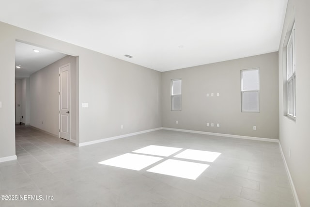 spare room featuring visible vents and baseboards