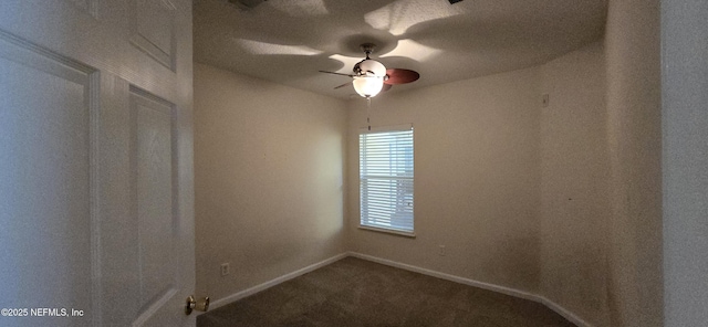 spare room featuring a ceiling fan, carpet, and baseboards