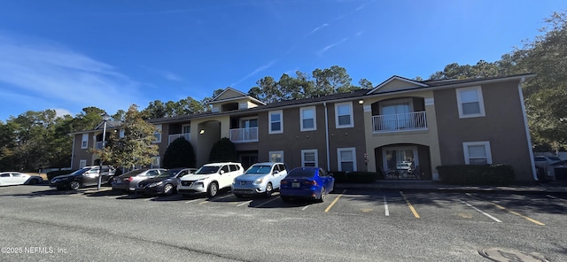 view of building exterior with uncovered parking