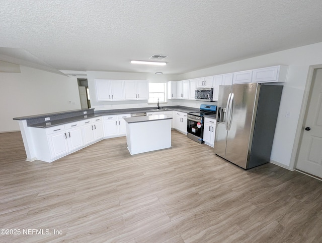 774 Barrington Dr, Fernandina Beach, FL 32034 - kitchen with visible vents, a sink, a textured ceiling, and appliances with stainless steel finishes
