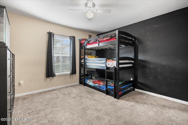 carpeted bedroom featuring a textured ceiling, ceiling fan, and baseboards