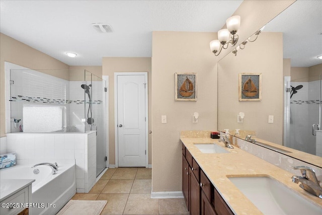 bathroom with a stall shower, a sink, and tile patterned floors