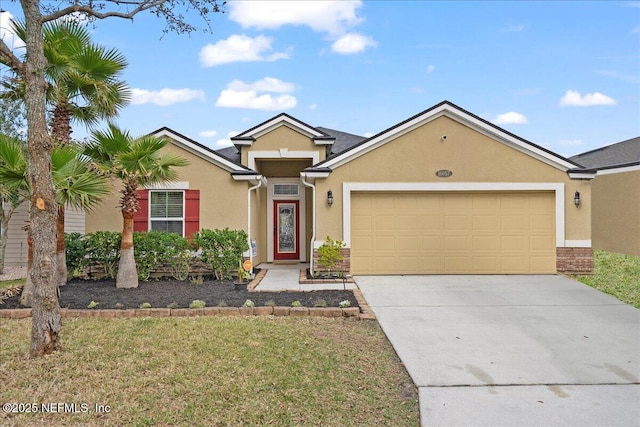 ranch-style home featuring an attached garage, concrete driveway, and stucco siding