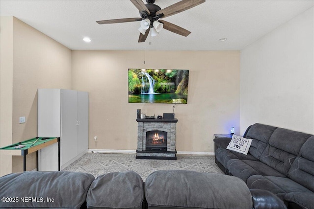 living area featuring a ceiling fan, recessed lighting, a fireplace, and baseboards