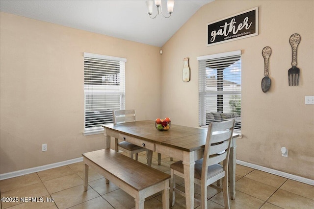 dining space with light tile patterned floors, plenty of natural light, and vaulted ceiling