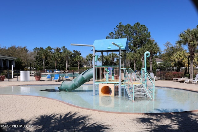 communal playground with fence and a water play area