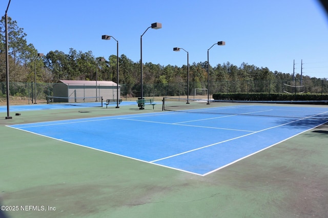 view of sport court featuring fence