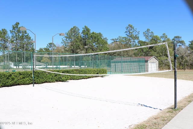 view of home's community featuring fence and volleyball court