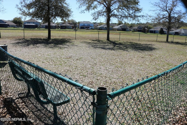 view of community with a residential view and fence