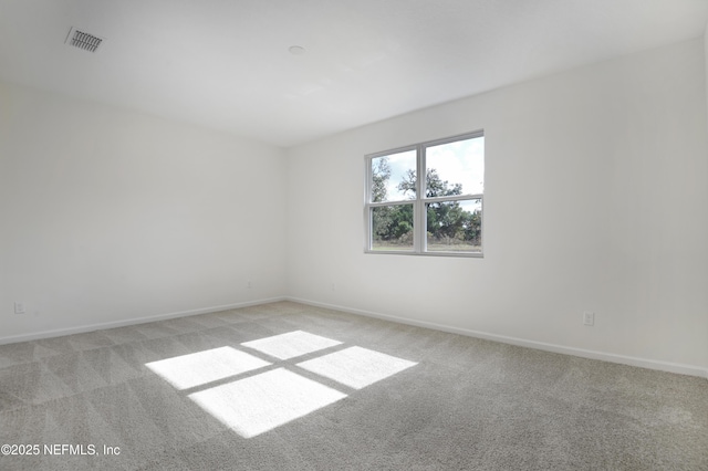 unfurnished room with light carpet, baseboards, and visible vents