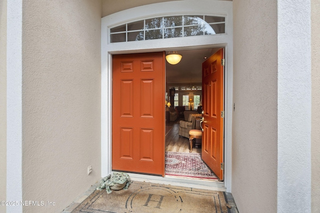 view of exterior entry featuring stucco siding