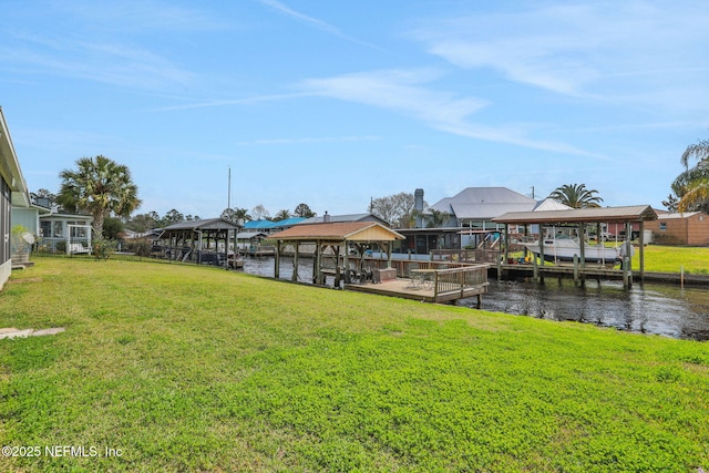 view of dock with a yard, a water view, and boat lift