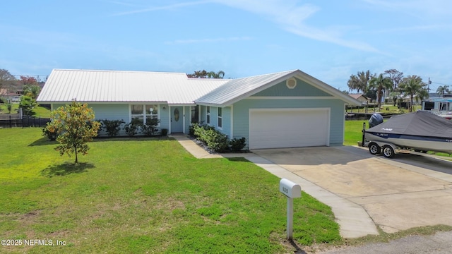 ranch-style home with a front yard, concrete driveway, and an attached garage