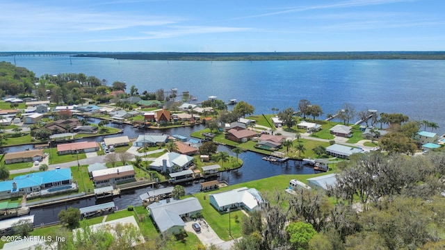 birds eye view of property with a water view and a residential view