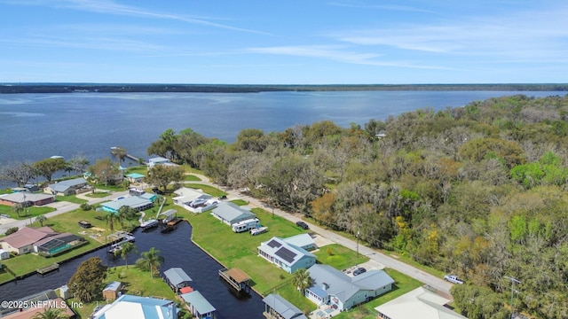 birds eye view of property featuring a water view, a residential view, and a view of trees