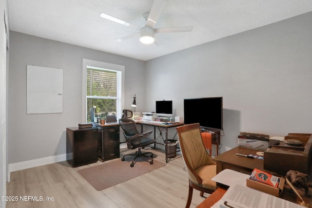 home office with baseboards, a textured ceiling, a ceiling fan, and wood finished floors