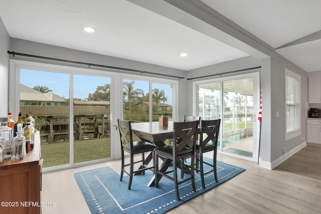dining area featuring light wood-style flooring, baseboards, and recessed lighting