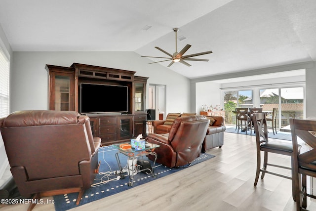 living area with vaulted ceiling, ceiling fan, and wood finished floors