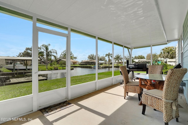 sunroom featuring a water view and a wealth of natural light