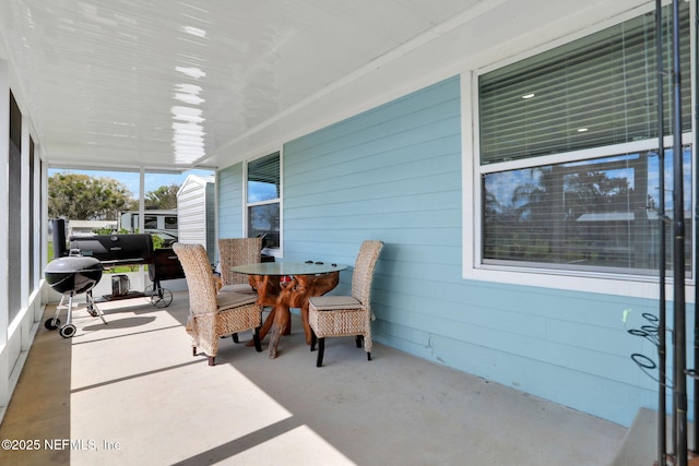 view of patio / terrace with a porch and a grill
