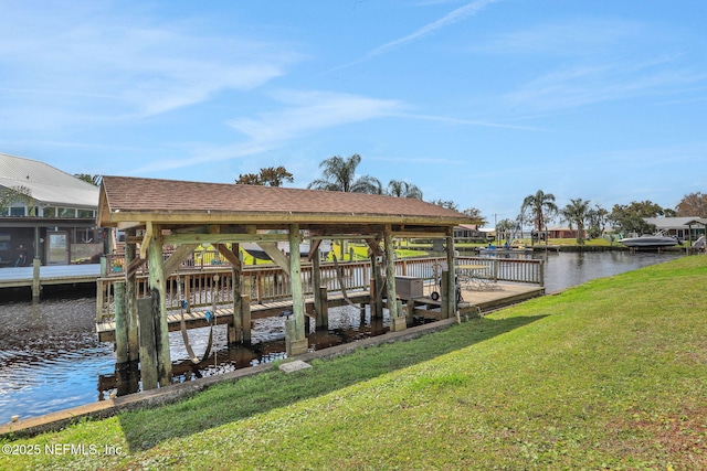 dock area with a water view and a yard