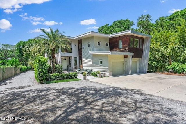 2446 Seminole Rd, Atlantic Beach, FL 32233 - view of front facade featuring driveway, an attached garage, and fence