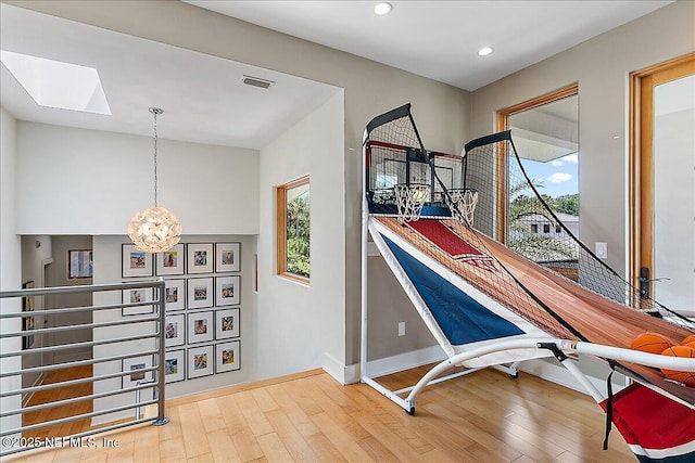 2446 Seminole Rd, Atlantic Beach, FL 32233 - living area featuring a skylight, recessed lighting, visible vents, hardwood / wood-style floors, and baseboards