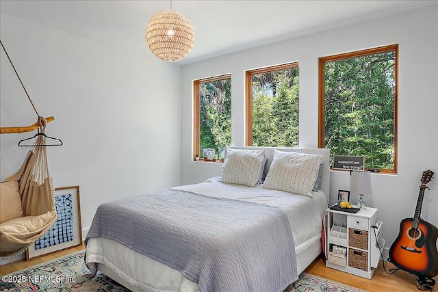 2446 Seminole Rd, Atlantic Beach, FL 32233 - bedroom with light wood-type flooring and a notable chandelier