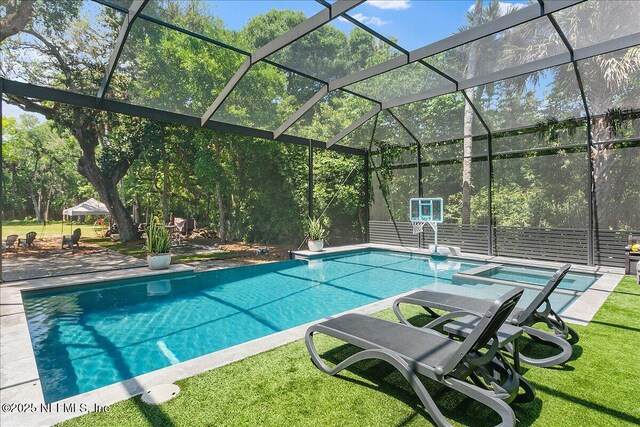 2446 Seminole Rd, Atlantic Beach, FL 32233 - view of swimming pool featuring a lanai, a patio area, a pool with connected hot tub, and a lawn