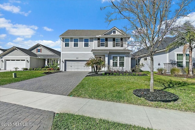 view of front facade with an attached garage, decorative driveway, and a front lawn