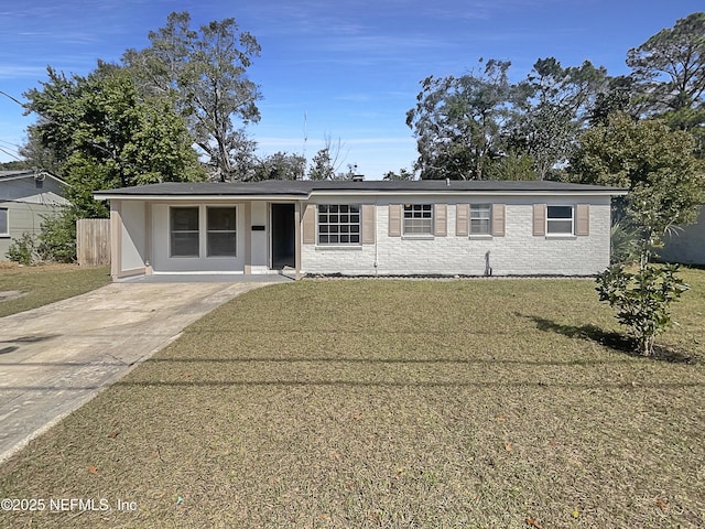 view of front of house with a front lawn and brick siding