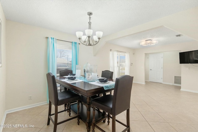 dining area with visible vents, light tile patterned flooring, a textured ceiling, and baseboards