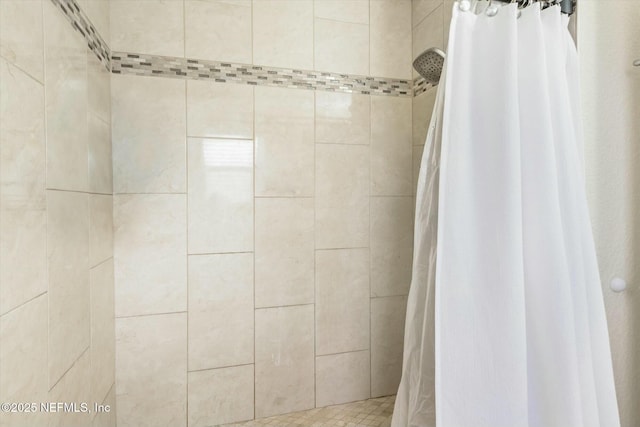 bathroom with tiled shower