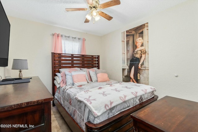 bedroom with a textured ceiling and a ceiling fan