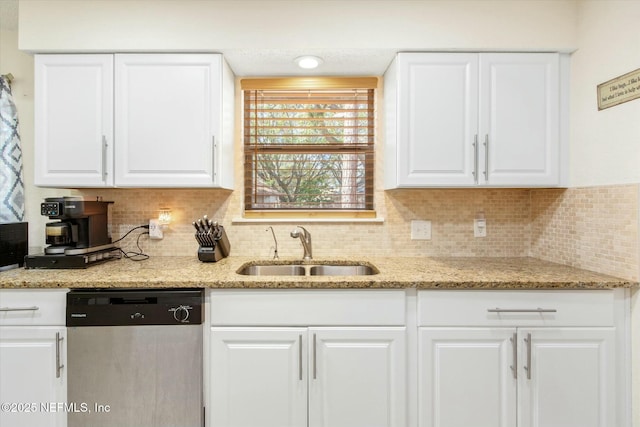 kitchen featuring a sink, tasteful backsplash, white cabinetry, and dishwasher