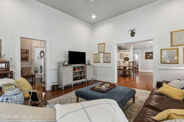 living room with a high ceiling and wood finished floors