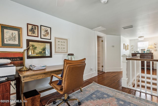 home office with baseboards and dark wood-type flooring