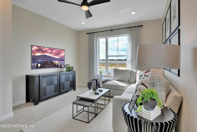 living room with ceiling fan, light wood finished floors, recessed lighting, and baseboards