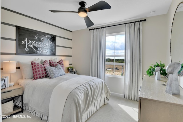 bedroom featuring light carpet and a ceiling fan