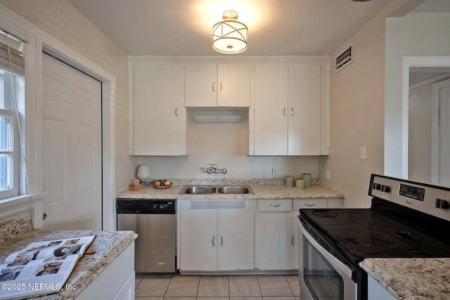 kitchen with visible vents, appliances with stainless steel finishes, light tile patterned flooring, white cabinets, and a sink