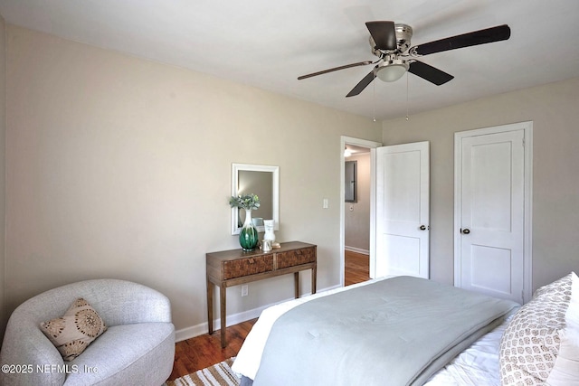 bedroom featuring a ceiling fan, baseboards, and wood finished floors