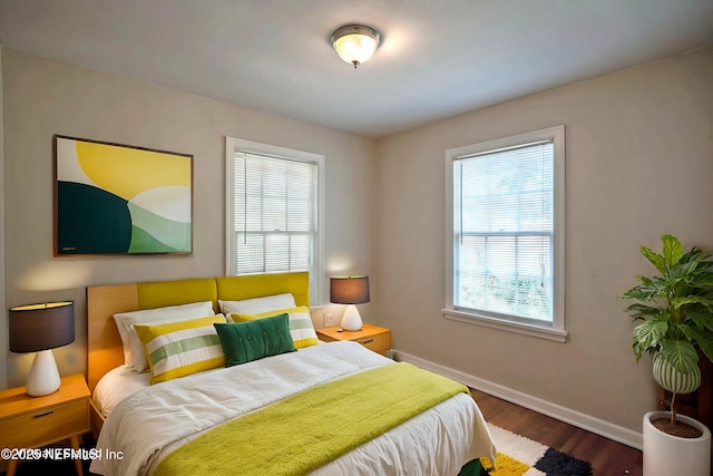 bedroom with baseboards and wood finished floors