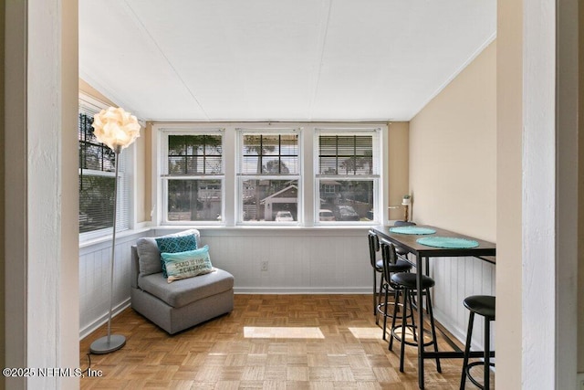 sunroom featuring a healthy amount of sunlight and a bar