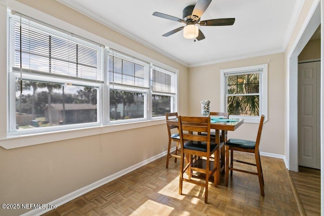 dining room featuring a ceiling fan, crown molding, and baseboards