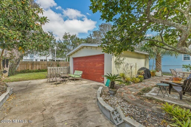 detached garage featuring fence