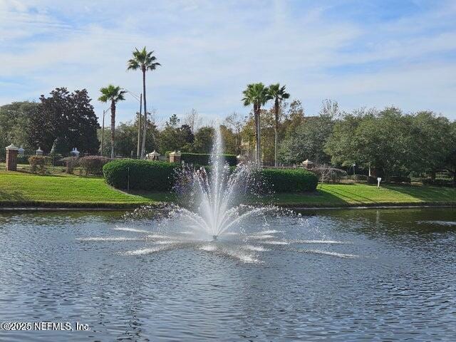 surrounding community featuring a water view and a yard