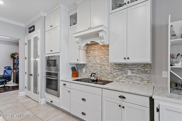 kitchen with crown molding, white cabinets, appliances with stainless steel finishes, glass insert cabinets, and custom range hood