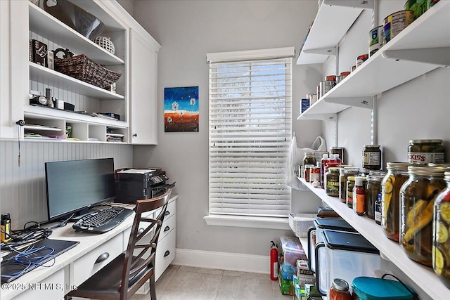 office with a wealth of natural light, baseboards, and light tile patterned floors